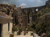 Buy Boy Sits in Front of the Bridge Which Connects Ronda at AllPosters.com
