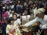 Buy Vendor Offers Cotton Candy to Girl in Kimono, Nearby Crowd Watches at AllPosters.com