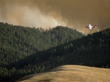 Buy Firefighting Plane Prepares to Drop Retardant on a Forest Fire at AllPosters.com