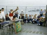 Acrobat Entertains Sailors Aboard a Navy Ship in Hong Kong Harbor