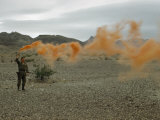 Buy Man Shows Wind Direction with Smoke Grenade for Nearby Helicopter at AllPosters.com