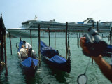 Buy Tourist Ship Pulls into Venice as a Gondolier Secures His Boat at AllPosters.com
