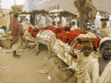 Buy Boys Walk Past a Fez Vendor's Table in an Open-Air Market at AllPosters.com