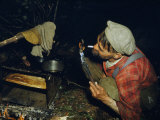 Buy Man Lights a Hand-Rolled Cigarette with a Firebrand at AllPosters.com