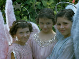 Smiling Young Girls Wear Angel Costumes for an Easter Procession