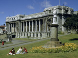 Women Sit on Lawn Near Parliament