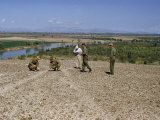 Buy Men Measure Furrows of Giant Figure Etched into Mesa's Soil at AllPosters.com