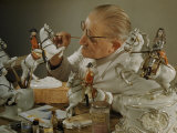 Craftsman Retouches Paint on Porcelain Figurines before Refiring