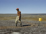 Scientist Drags a Magnet across Tundra to Pick Up Ore Particles