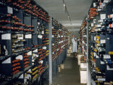Buy Restaurant Employee Inspects Vintage Bottles in a Wine Cellar at AllPosters.com
