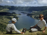 Men with Puppy Overlook Hourglass-Shaped Lakes in Volcanic Crater