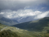 Buy Narrow Road Curls over a Mountain Pass Beneath Stormy Sky at AllPosters.com