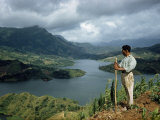 Buy Farmer Working Corn Patch Stops to Watch Storm over Distant Mountains at AllPosters.com