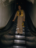 Pilot in Flight Suit Rides Escalator from Ready Room to Flight Deck