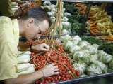Buy Man Studies Temperature of Merchandising Rack Using Thermocouples at AllPosters.com