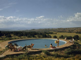 Buy Vacationers Relax Beside Pool Overlooking Plain and Distant Mountains at AllPosters.com