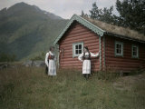 Wooden House and Two Norwegian Women in Traditional Dress