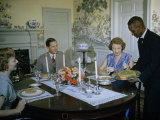 Buy Servant Holds Tray as Guest Takes Portion of Food, Host Watches at AllPosters.com