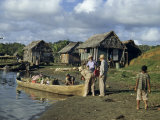 Buy Archeologists Load Supplies into a Dugout Canoe for an Expedition at AllPosters.com