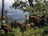 Buy Horseback-Riding Tourists Pause on Mountain Trail Overlooking Valley at AllPosters.com