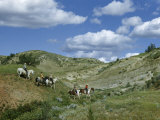 Buy People Ride Horses Through Badlands Molded by Erosion at AllPosters.com