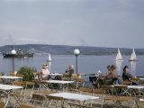 Buy People Relax in Sunshine at Terrace Overlooking Harbor at AllPosters.com