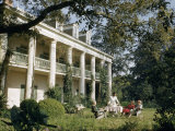 Buy Servant Brings Tea to Women Seated on Lawn Outside Plantation House at AllPosters.com