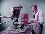Buy Man Uses Camera Mounted over Microscope to Photograph Rock Sections at AllPosters.com