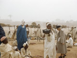 Buy American Tourist Walks Through Market Near Veiled Tuareg Tribesman at AllPosters.com