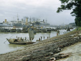 Buy Workers Board a Ferry from a Riverbank Lined by Salvaged Chains at AllPosters.com
