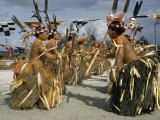 Buy Women in Grass Skirts and Feathered Headdresses Perform a Stick Dance at AllPosters.com