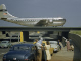 Buy Sightseers Park to Watch a Stratocruiser Taxi across an Underpass at AllPosters.com