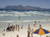 Buy Children Ride Ponies Along a Beach Past Sunbathers and Swimmers at AllPosters.com