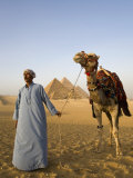 Camel Driver Stands in Front of the Pyramids at Giza, Egypt