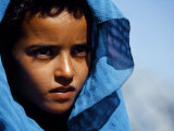 Young Girl in Characteristic Saharan Blue Headscarf Looking into Distance, Sahara, Southern Morocco
