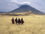 Maasai Warriors Stride across Golden Grass Plains at Foot of Ol Doinyo Lengai, 'Mountain of God'