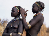 Dassanech Girl Braids Her Sister's Hair at Her Village in the Omo Delta