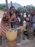 Cheerful Young Girls Pound Corn Outside Families' Homes Near Monkey Bay, South End of Lake Malawi