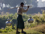Buy Burma, Mrauk U, A Rakhine Man Carries Water in Aluminium Pots Near Mrauk U, Myanmar at AllPosters.com
