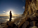 Silhouetted Figure Admires the Dramatic Coastal Landscape at Newhaven