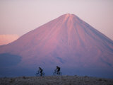 Mountain Biking in Atacama Desert Against a Backdrop of Perfect Cone of Volcan Licancabur 5916 M