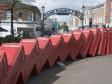 Red Telephone Box Sculpture Out of Order by David Mach. Kingston Upon Thames, Surrey