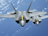 Two F-22 Raptors Fly over the Pacific Ocean