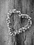 Frosted Heart-Shaped Metal Bell Wreath on Rustic Wooden Background