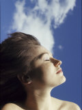 Buy Young Woman Profiled Against a Cloud Filled Sky on a Sunny Day at AllPosters.com