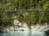 Hiker on a Swing Bridge over the Whitcombe River