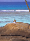 Young Woman Meditating on Rock, Seychelles, Indian Ocean, Africa