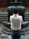 Prayer with Incense in the Shanghai White Jade Buddha Temple, Shanghai, China, Asia
