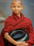 Young Myanmar Buddhist Monk Smiles Broadly as He Waits for Donations Early on a Yangon Street