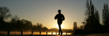 Jogger Silhouetted Against the Rising Sun as He Runs Past the Serpentine Lake in Hyde Park, London